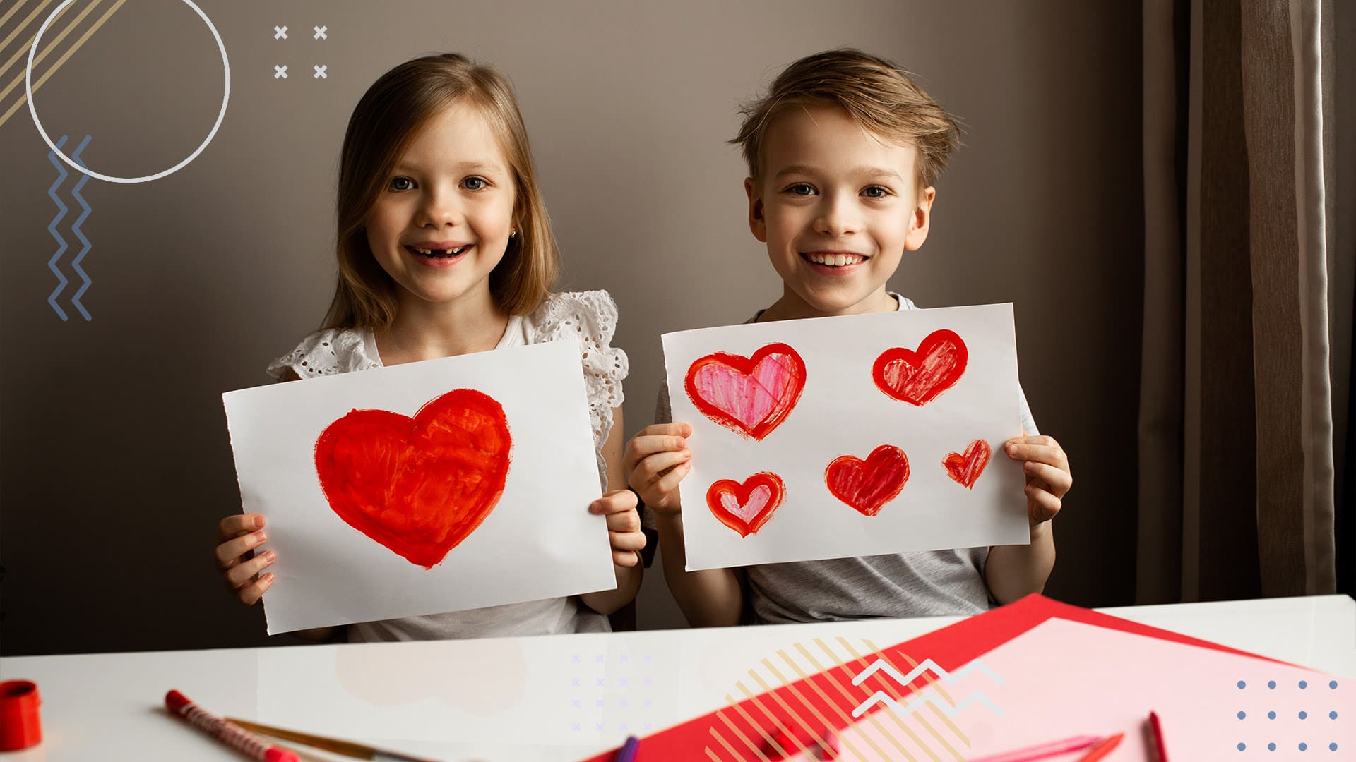 Two children holding up paper with marker drawings of hearts