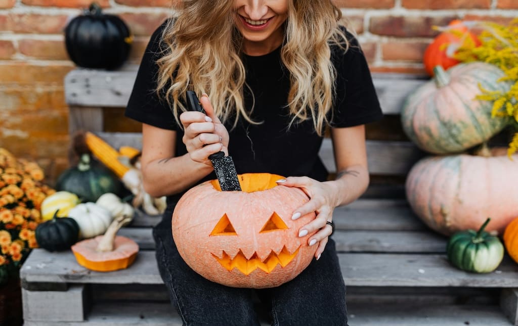 Woman carving a pumpkin