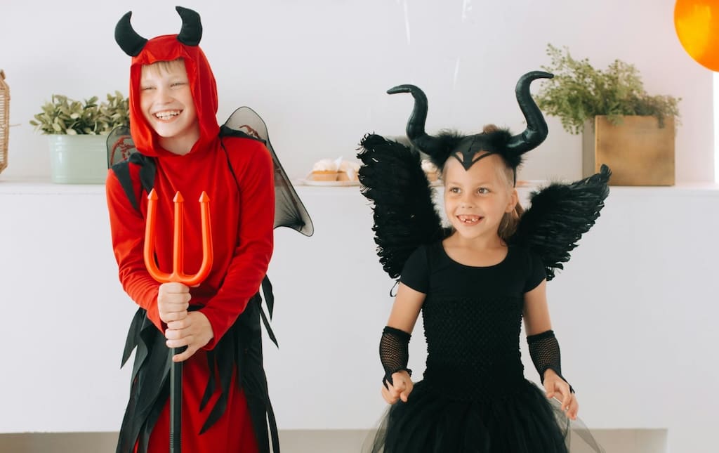 Two children in Halloween costumes