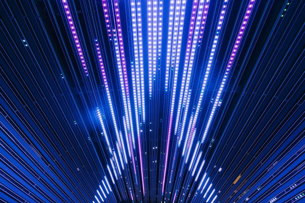 A tunnel with purple lighting running down the middle light show