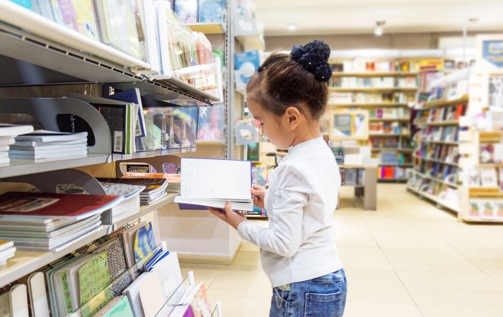 Kid looking at books in a store