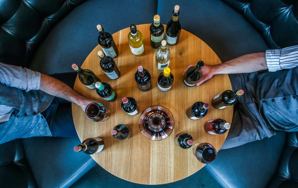 Table with many wine bottles on it