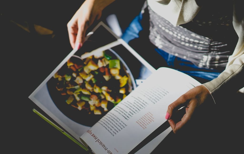 Woman looking a recipe book