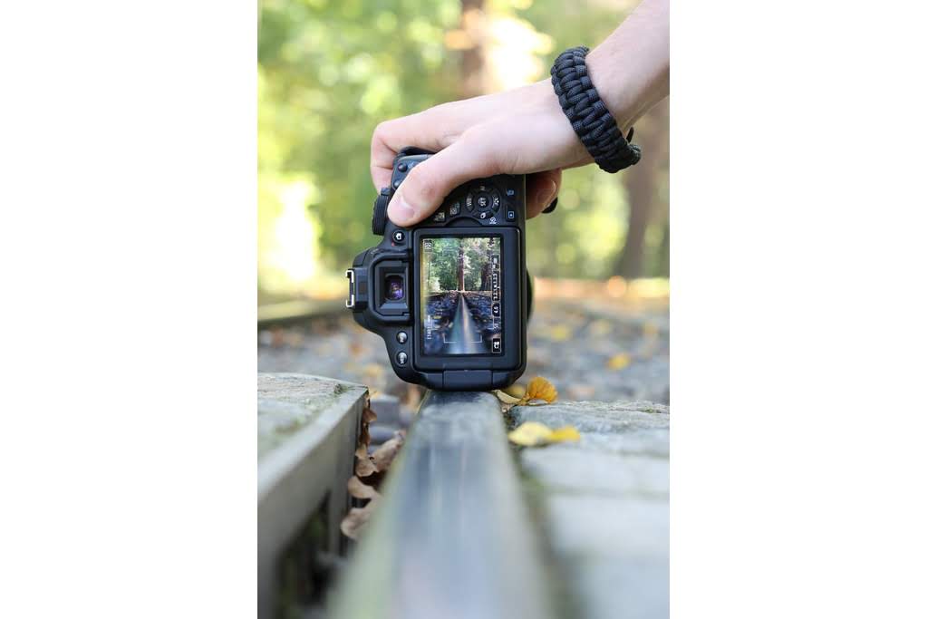 A handle holding a camera on a fence digital camera