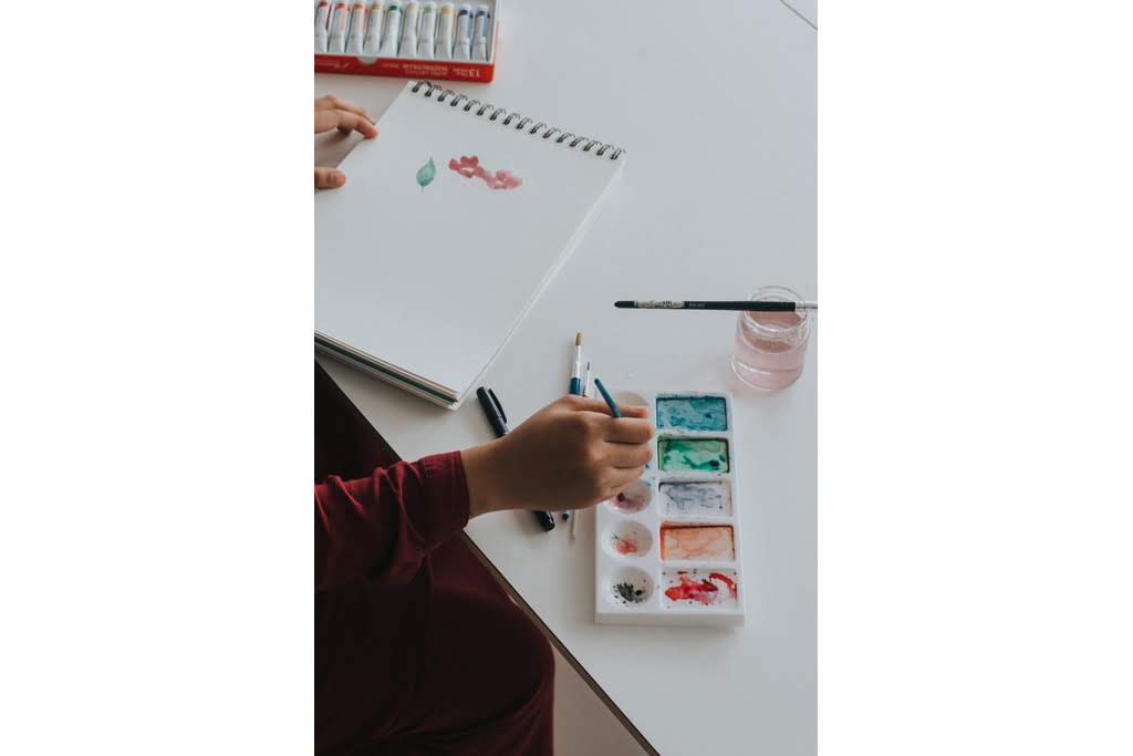 A teen painting with water colors woman painting