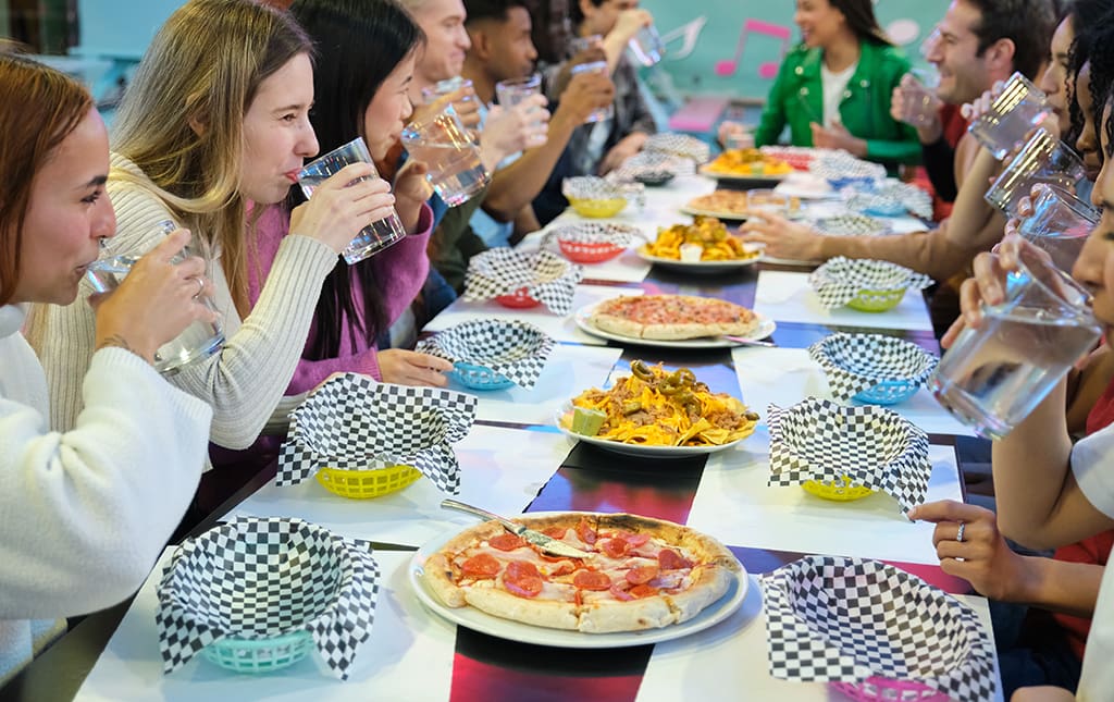 Teachers enjoy pizza and nachos at a buffet