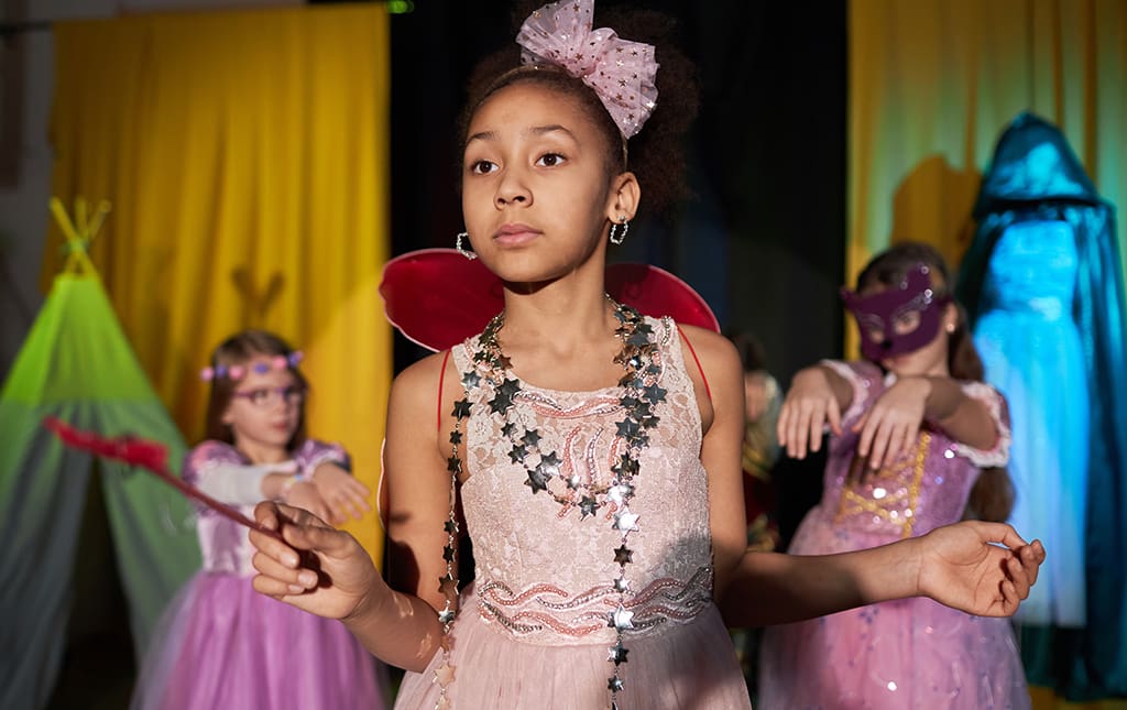 Kids in fairy costumes at a school fashion show