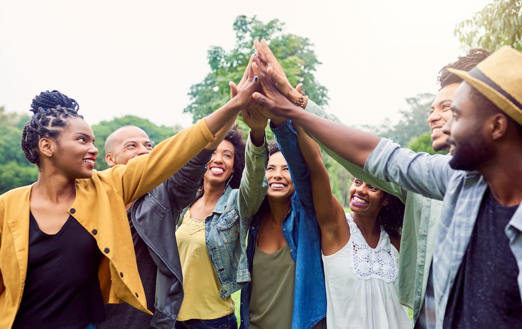Were each others motivation. Shot of a group of friends reaching for a high five