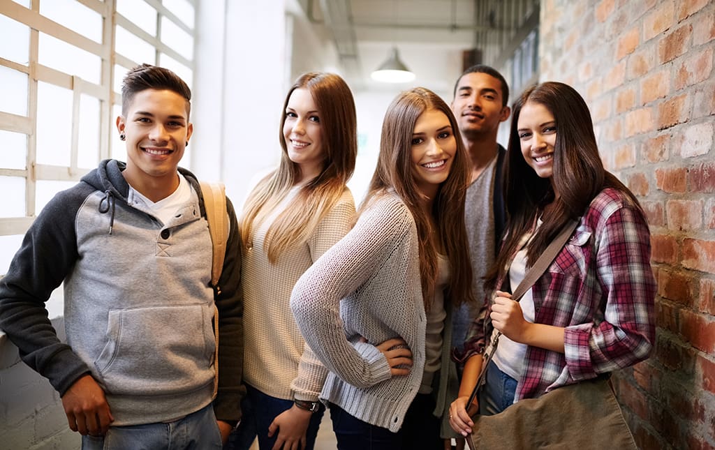 Recent graduates pause for a picture at an alumni event