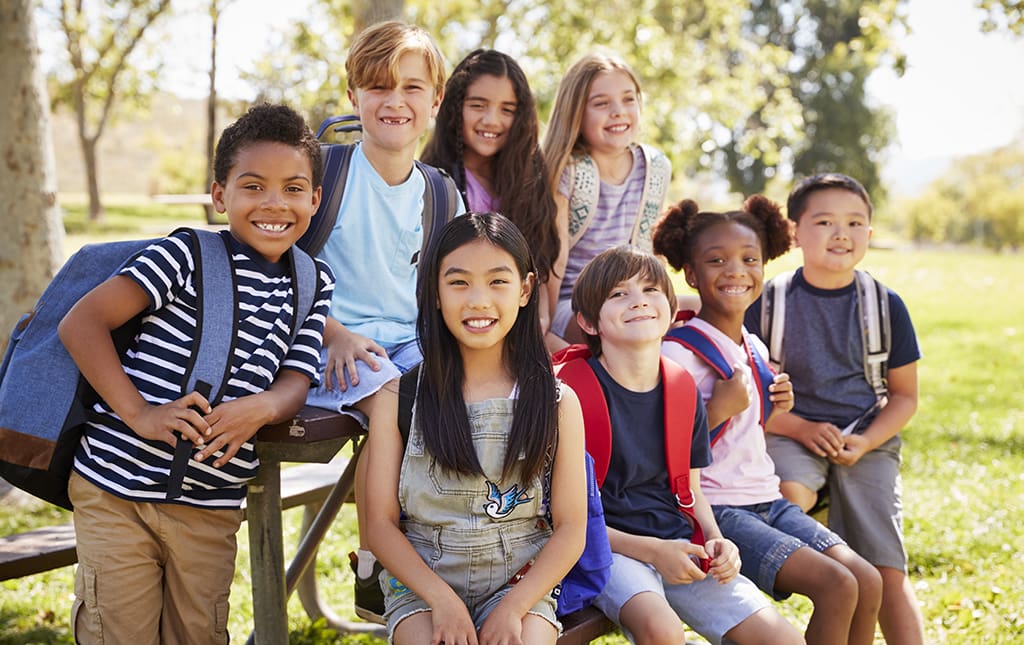 Kids sitting outside at school