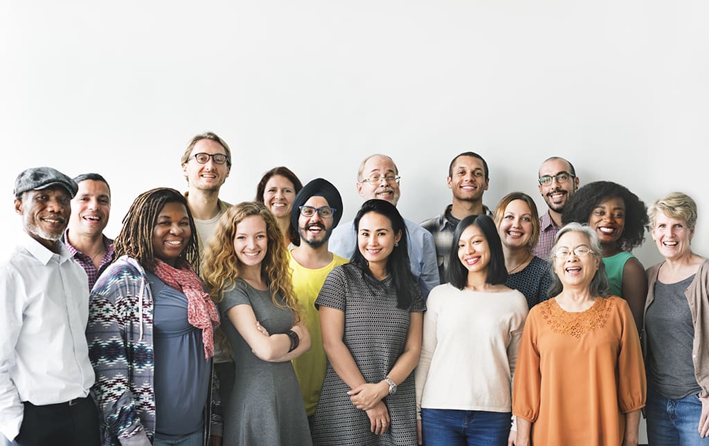 Diverse alumni stand together at a fundraising event