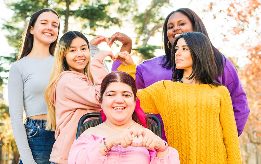 Alumni and high school students form hearts to show they care about school causes.