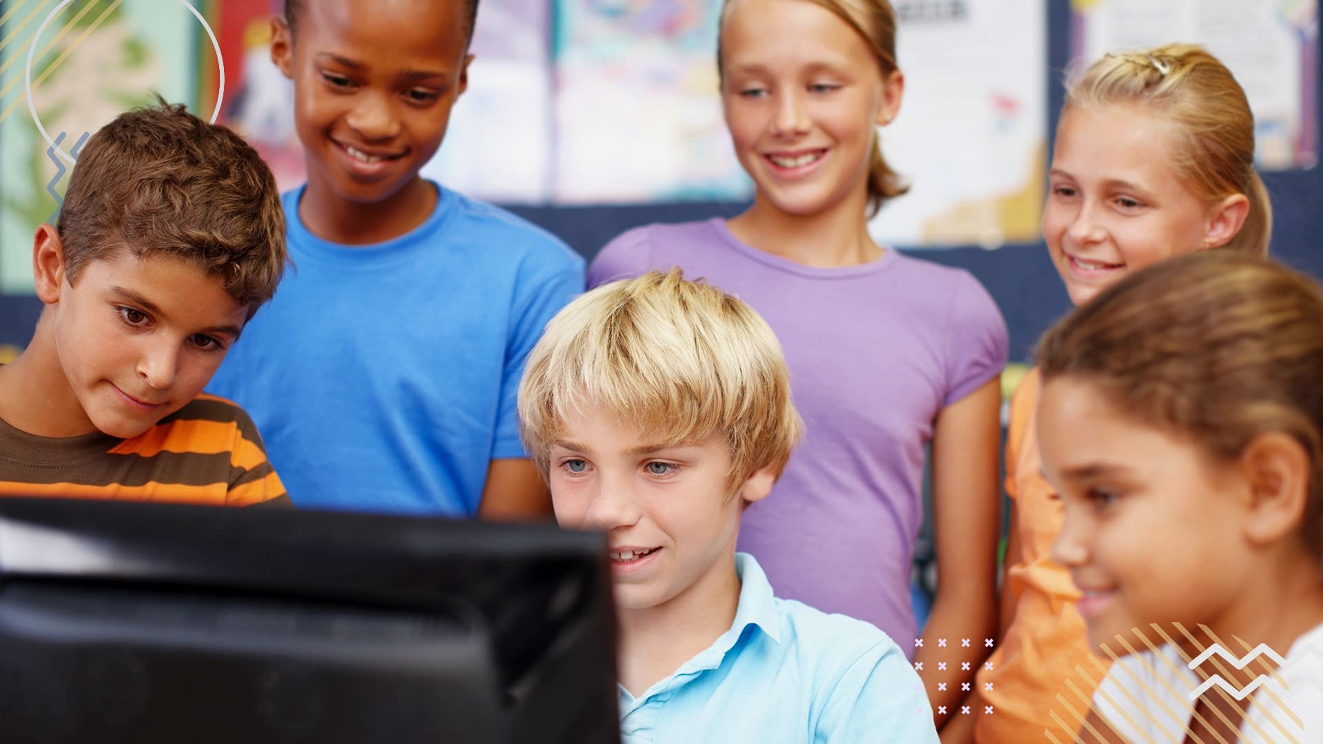 Group of students staring at computer screen at school
