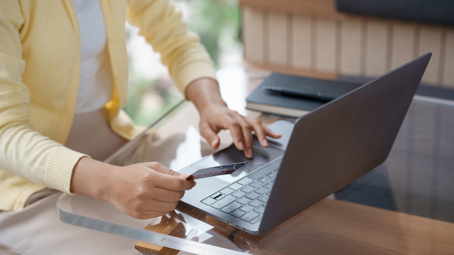 Close-up of woman using laptop and credit card for online shopping. Online payment. Image of woman making an online payment on laptop with FutureFund BeeKeeper