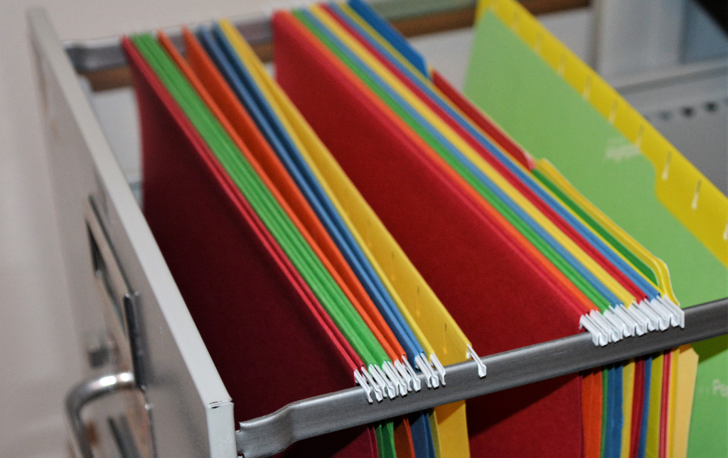 Colorful file folders in a file cabinet.